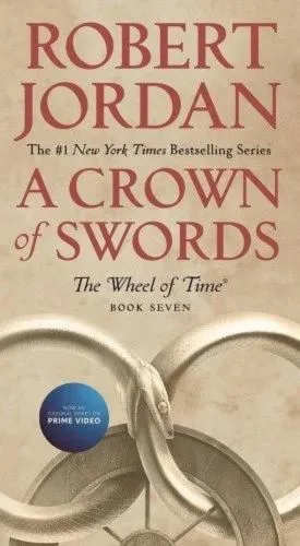 A Crown of Swords paperback, February 2020 mass-market edition from Tor Books. The cover has the snake-wheel symbol on a sand-brown background.