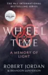 A Memory of Light paperback, Orbit's September 2021 edition. The cover depicts a blast of light at the top of a dark mountain.