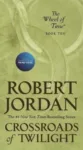 Crossroads of Twilight paperback, April 2020 mass-market edition from Tor Books. The cover has the snake-wheel symbol on a khaki background.