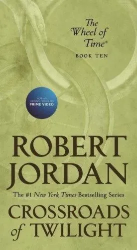 Crossroads of Twilight paperback, April 2020 mass-market edition from Tor Books. The cover has the snake-wheel symbol on a khaki background.
