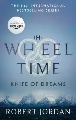 Knife of Dreams paperback, Orbit's September 2021 edition. The cover depicts snow-tipped mountains and a silvery sky.