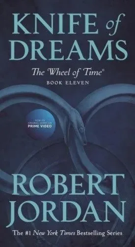Knife of Dreams paperback, April 2020 mass-market edition from Tor Books. The cover has the snake-wheel symbol on a dark blue background.