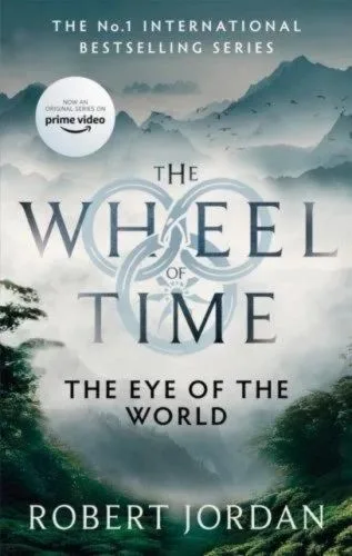 The Eye of the World paperback, Orbit's September 2021 edition. The cover depicts trees in the foreground and misty mountains beyond.