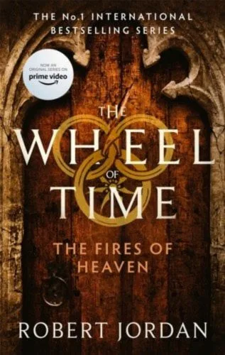 The Fires of Heaven paperback, Orbit's September 2021 edition. The cover depicts a wooden door with a stone border.