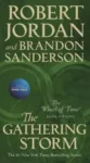 The Gathering Storm paperback, April 2020 mass-market edition from Tor Books. The cover has the snake-wheel symbol on a green background.
