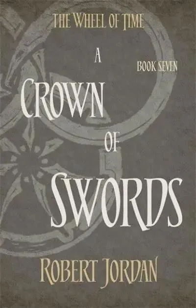 A Crown of Swords paperback, Orbit's 2014 edition. The cover has the snake-wheel symbol on a gray background.