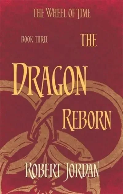 The Dragon Reborn paperback, Orbit's 2014 edition. The cover has the snake-wheel symbol on a burgundy background.