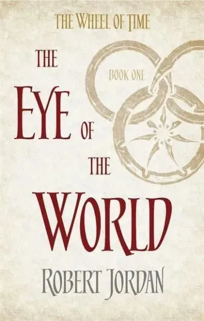 The Eye of the World paperback, Orbit's 2014 edition. The cover has the snake-wheel symbol on an ivory background.