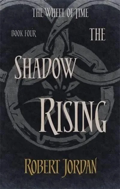 The Shadow Rising paperback, Orbit's 2014 edition. The cover has the snake-wheel symbol on a charcoal background.