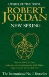New Spring hardcover, January 2004 edition from Orbit. The cover has a gold snake-wheel symbol on a green background.