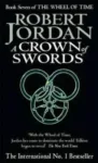 A Crown of Swords paperback. Time Warner Books UK's 1997 edition. The cover has a green snake-wheel symbol on a black background.