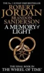 A Memory of Light paperback. Orbit's 2013 edition. The cover has a gold snake-wheel symbol on a black background.