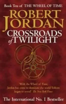 Crossroads of Twilight hardcover, January 2003 edition from Orbit. The cover has a gold snake-wheel symbol on a red-pattern background.