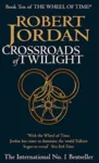 Crossroads of Twilight paperback. Orbit's 2003 edition. The cover has an orange snake-wheel symbol on a black background.