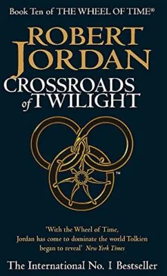Crossroads of Twilight paperback. Orbit's 2003 edition. The cover has an orange snake-wheel symbol on a black background.