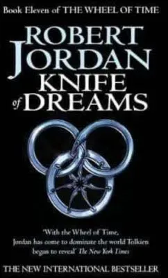 Knife of Dreams paperback. Orbit's 2006 edition. The cover has a silver snake-wheel symbol on a black background.