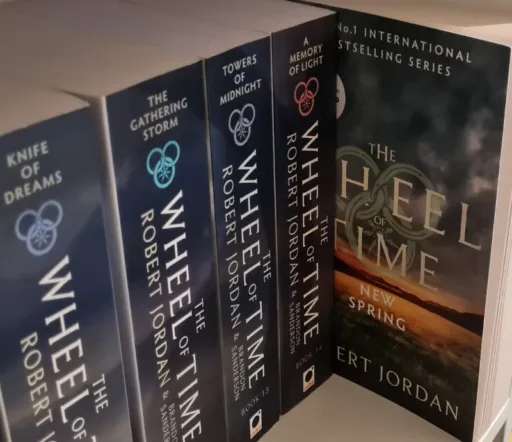 The Wheel of Time books on a shelf with New Spring pulled forwards. Signifying its position if you read New Spring after finishing The Wheel of Time.