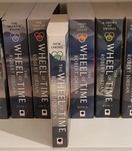 The Wheel of Time books on a shelf with New Spring pulled forwards. Signifying its position if you read New Spring after The Fires of Heaven.