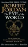 The Eye of the World paperback. Orbit's 1991 edition. The cover has a yellow snake-wheel symbol on a black background.