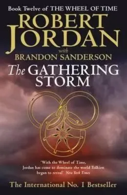 The Gathering Storm hardcover, October 2009 edition from Orbit. The cover has a gold snake-wheel symbol on a stormy background.