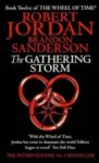 The Gathering Storm paperback. Orbit's 2010 edition. The cover has a red snake-wheel symbol on a black background.