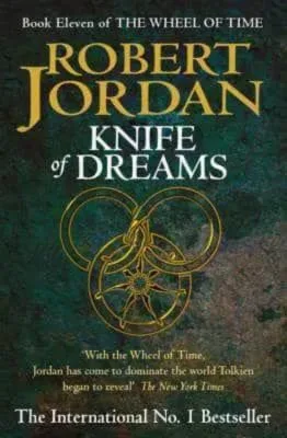 Knife of Dreams paperback, October 2005 edition from Orbit. The cover has a gold snake-wheel symbol on a green-pattern background.